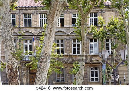 Stock Photograph - Trees in front of building, Aix-En-Provence, Bouches-Du-Rhone, Provence-Alpes-Cote d'Azur, France . Fotosearch