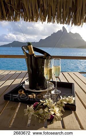 Two champagne glasses with bottle at resort View Large Photo Image Stock Image - Two champagne glasses with bottle at resort . Fotosearch