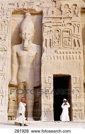 Two people in front of Egyptian temple, Nefertaris Temple Of Hathor, Abu Simbel, Egypt View Large Photo Image Stock Photo - Two people in front of Egyptian temple, Nefertaris Temple Of Hathor, Abu Simbel, Egypt . Fotosearch