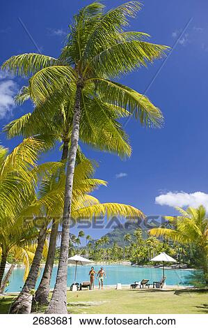 Two people standing at poolside, Saint-Regis Resort, Bora Bora, Society Island, French Polynesia View Large Photo Image Stock Image - Two people standing at poolside, Saint-Regis Resort, Bora Bora, Society Island, French Polynesia . Fotosearch