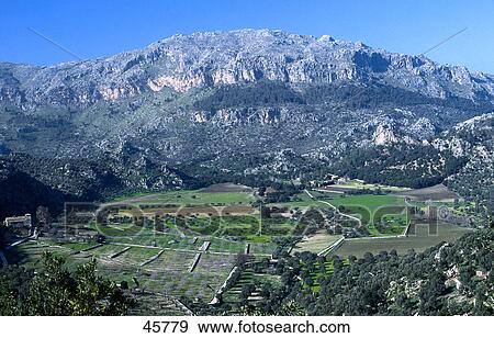 Stock Photo - Valley surrounded by mountain ranges, Serra de Tramuntana, Puig Roig, Majorca, Balearic Islands, Spain . Fotosearch