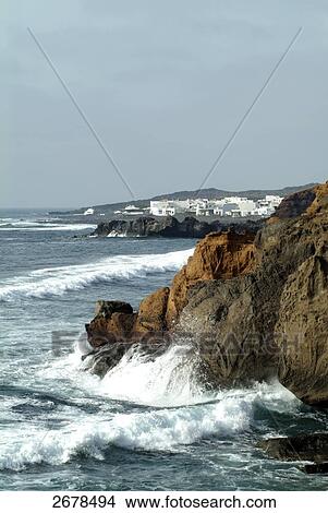 Picture - Waves breaking against rocks, El Golfo, Lanzarote, Canary Islands, Spain . Fotosearch