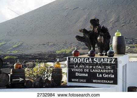 Picture - Wine bottles on roof winery, La Geria, Bodega, Lanzarote, Canary Islands, Spain . Fotosearch