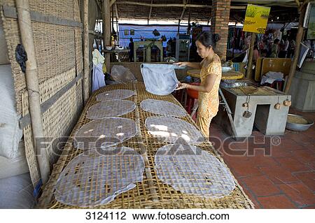 Woman processing rice, Can Tho, Vietnam View Large Photo Image Stock Image - Woman processing rice, Can Tho, Vietnam . Fotosearch