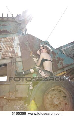 Woman sitting on wheel View Large Photo Image Stock Photo - Woman sitting on wheel . Fotosearch