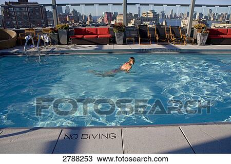 Woman swimming in pool, Gansevoort Hotel, Manhattan, New York City, New York State, USA View Large Photo Image Stock Image - Woman swimming in pool, Gansevoort Hotel, Manhattan, New York City, New York State, USA . Fotosearch