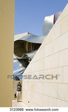 Woman walking in a corridor, roof of the Marques de Riscal hotel in the background, Elciego, Spain View Large Photo Image Stock Photo - Woman walking in a corridor, roof of the Marques de Riscal hotel in the background, Elciego, Spain . Fotosearch