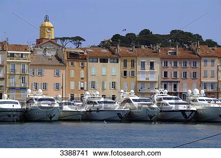 Stock Image - Yachts in a row at the harbour of St. Tropez, France . Fotosearch