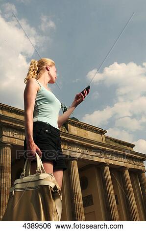 Young woman at Brandenburg Gate, Berlin, Germany, Europe View Large Photo Image Stock Photograph - Young woman at Brandenburg Gate, Berlin, Germany, Europe . Fotosearch