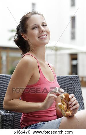Young woman eating pretzel View Large Photo Image Stock Image - Young woman eating pretzel . Fotosearch