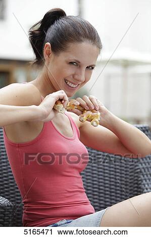 Young woman eating pretzel View Large Photo Image Stock Image - Young woman eating pretzel . Fotosearch