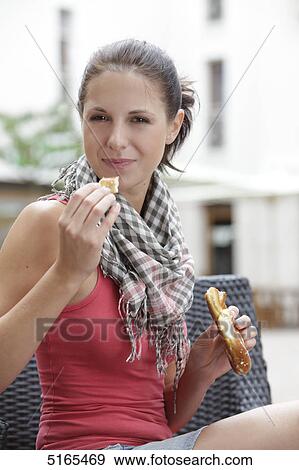 Young woman eating pretzel View Large Photo Image Stock Photo - Young woman eating pretzel . Fotosearch