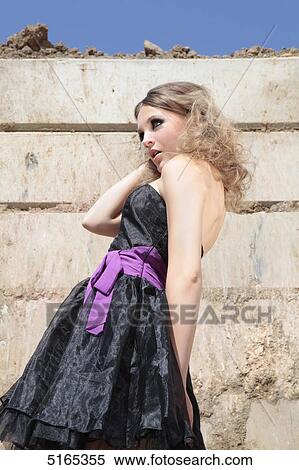 Stock Photography - Young woman in black dress . Fotosearch