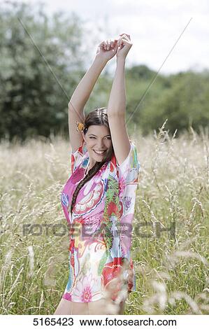 Stock Image - Young woman in corn field . Fotosearch