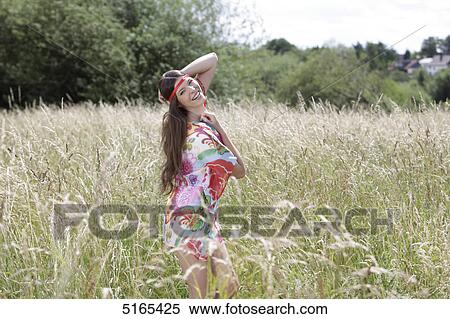 Stock Photography - Young woman in corn field . Fotosearch