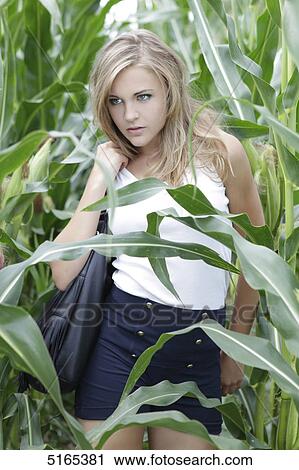 Stock Image - Young woman in cornfield . Fotosearch
