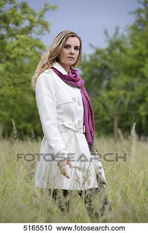 Young woman in white trench coat View Large Photo Image Stock Image - Young woman in white trench coat . Fotosearch