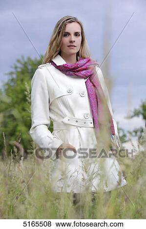Young woman in white trench coat View Large Photo Image Stock Photo - Young woman in white trench coat . Fotosearch