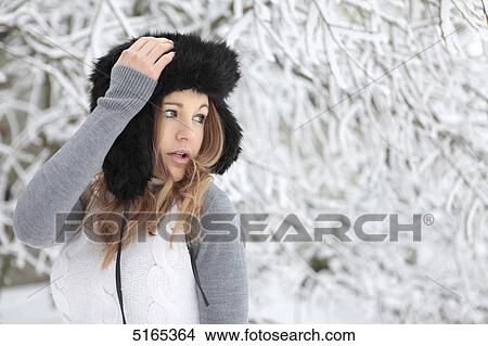 Young woman with cap in snow View Large Photo Image Picture - Young woman with cap in snow . Fotosearch