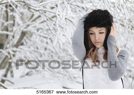 Young woman with cap in snow View Large Photo Image Stock Photo - Young woman with cap in snow . Fotosearch