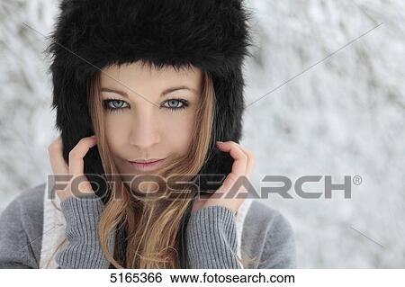 Young woman with cap in snow View Large Photo Image Stock Photograph - Young woman with cap in snow . Fotosearch
