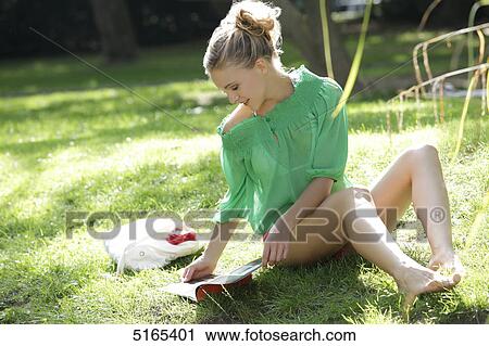 Stock Image - Young woman with green blouse, portrait . Fotosearch
