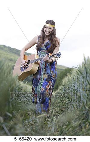 Young woman with guitar in corn field View Large Photo Image Stock Image - Young woman with guitar in corn field . Fotosearch