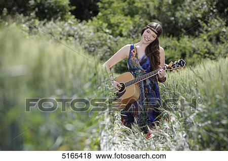 Young woman with guitar in corn field View Large Photo Image Stock Photo - Young woman with guitar in corn field . Fotosearch