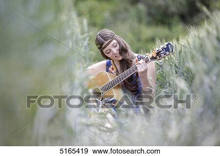 Young woman with guitar in corn field View Large Photo Image Stock Photo - Young woman with guitar in corn field . Fotosearch