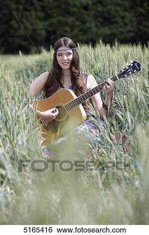 Young woman with guitar in corn field View Large Photo Image Stock Photograph - Young woman with guitar in corn field . Fotosearch