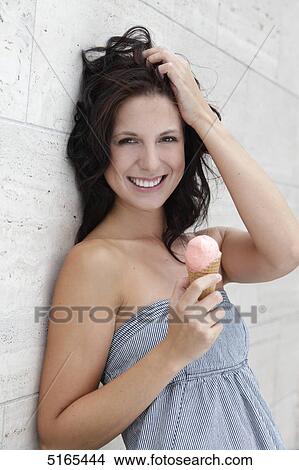 Picture - Young woman with ice dream . Fotosearch