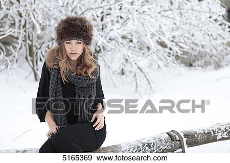 Young woman with scarf and cap in snow View Large Photo Image Stock Photo - Young woman with scarf and cap in snow . Fotosearch