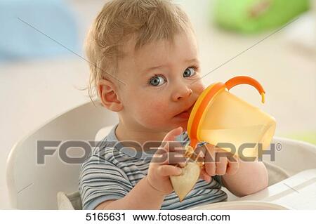 Baby drinking at table View Large Photo Image Stock Image - Baby drinking at table . Fotosearch