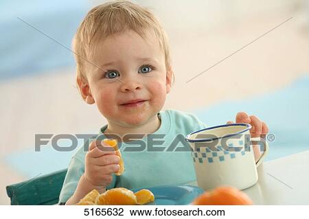 Baby eating at table View Large Photo Image Stock Image - Baby eating at table . Fotosearch