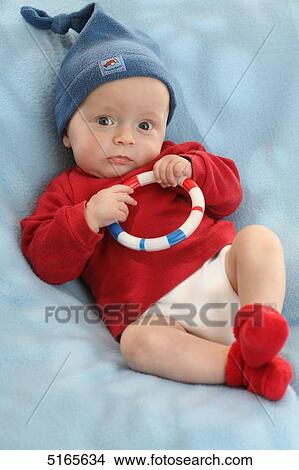 Picture - Baby lying on blanket . Fotosearch