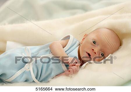 Baby lying on blanket View Large Photo Image Picture - Baby lying on blanket . Fotosearch