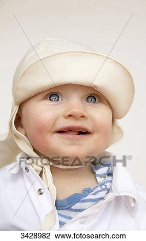 Stock Image - Baby wearing cap, portrait . Fotosearch