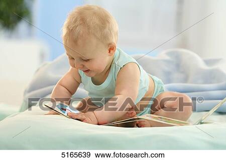 Stock Photo - Baby with a picture book . Fotosearch