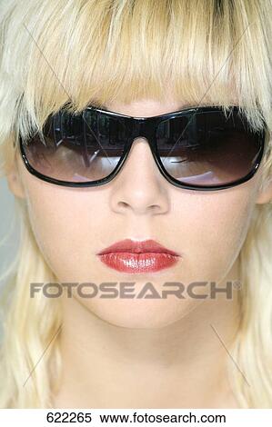 Blond woman with sunglasses, portrait View Large Photo Image Stock Photography - Blond woman with sunglasses, portrait . Fotosearch