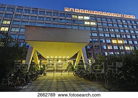 Stock Photo - Building lit up at dusk, Neues Deutschland, Berlin, Germany . Fotosearch