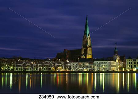 Buildings lit up at dusk, Schwerin, Mecklenburg Western-Pomerania, Germany View Large Photo Image Stock Image - Buildings lit up at dusk, Schwerin, Mecklenburg Western-Pomerania, Germany . Fotosearch