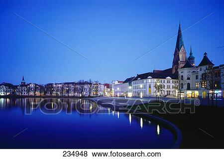 Stock Photo - Buildings lit up at dusk, Schwerin, Mecklenburg Western-Pomerania, Germany . Fotosearch