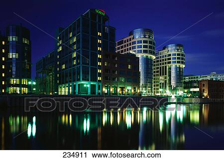 Buildings lit up in city at night, Spree River, Berlin, Germany View Large Photo Image Stock Image - Buildings lit up in city at night, Spree River, Berlin, Germany . Fotosearch