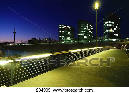 Stock Photo - Buildings lit up in city at night, Spree River, Alexanderplatz, Berlin, Germany . Fotosearch