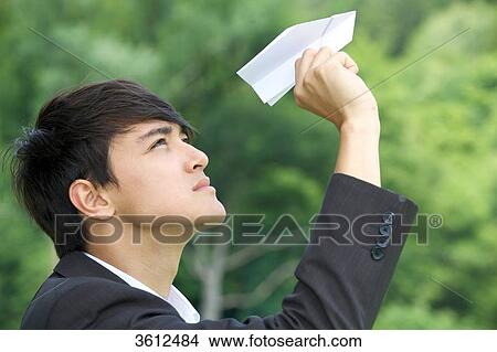 Businessman holding toy airplane, profile View Large Photo Image Picture - Businessman holding toy airplane, profile . Fotosearch