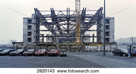 Cars parked in parking lot with construction site in background View Large Photo Image Stock Image - Cars parked in parking lot with construction site in background . Fotosearch