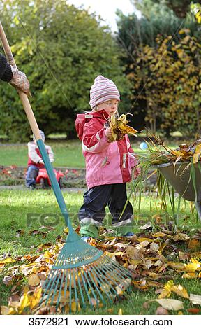 Stock Image - Children in garden in autumn . Fotosearch