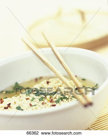 Close-up of a dish of noodle soup with chopsticks View Large Photo Image Stock Image - Close-up of a dish of noodle soup with chopsticks . Fotosearch