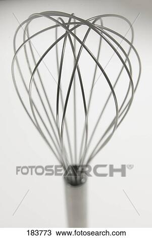 Stock Image - Close-up of eggbeater against white background . Fotosearch