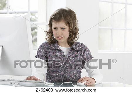 Close-up of girl working on computer View Large Photo Image Stock Image - Close-up of girl working on computer . Fotosearch
